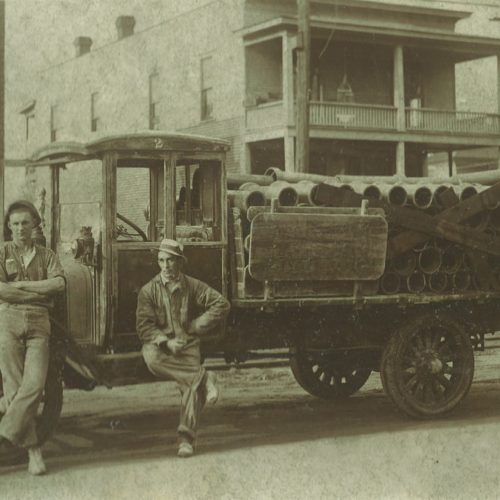 old photograph of young bros & daley truck and workers